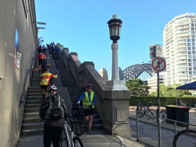 For decades this has been the only way that cyclists can cross the Sydney Harbour Bridge, by either carrying or pushing their bicycles up five steep flights of stairs. Bicycle NSW photo.